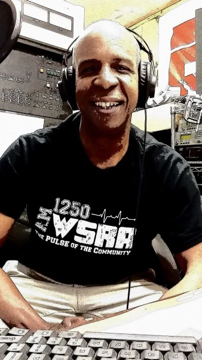 TCB in a black WSRA shirt at the radio console