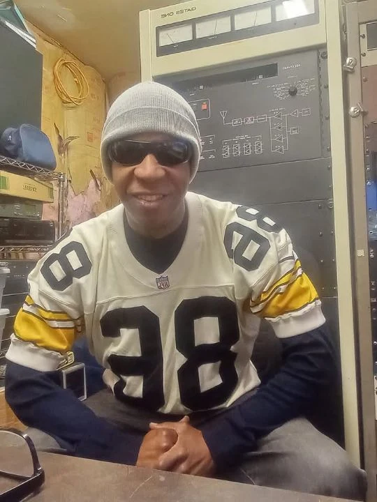 TCB wearing a football jersey in the studio
