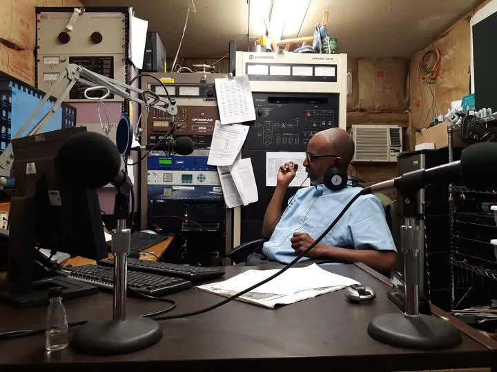 TCB broadcasting at the studio desk